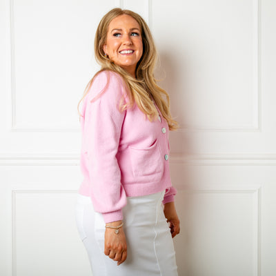 The candy pink Pearl Button Cardigan with pockets on either side and baggy balloon sleeves